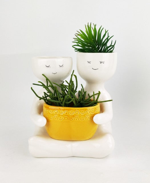 Friends holding a pot planter Mustard