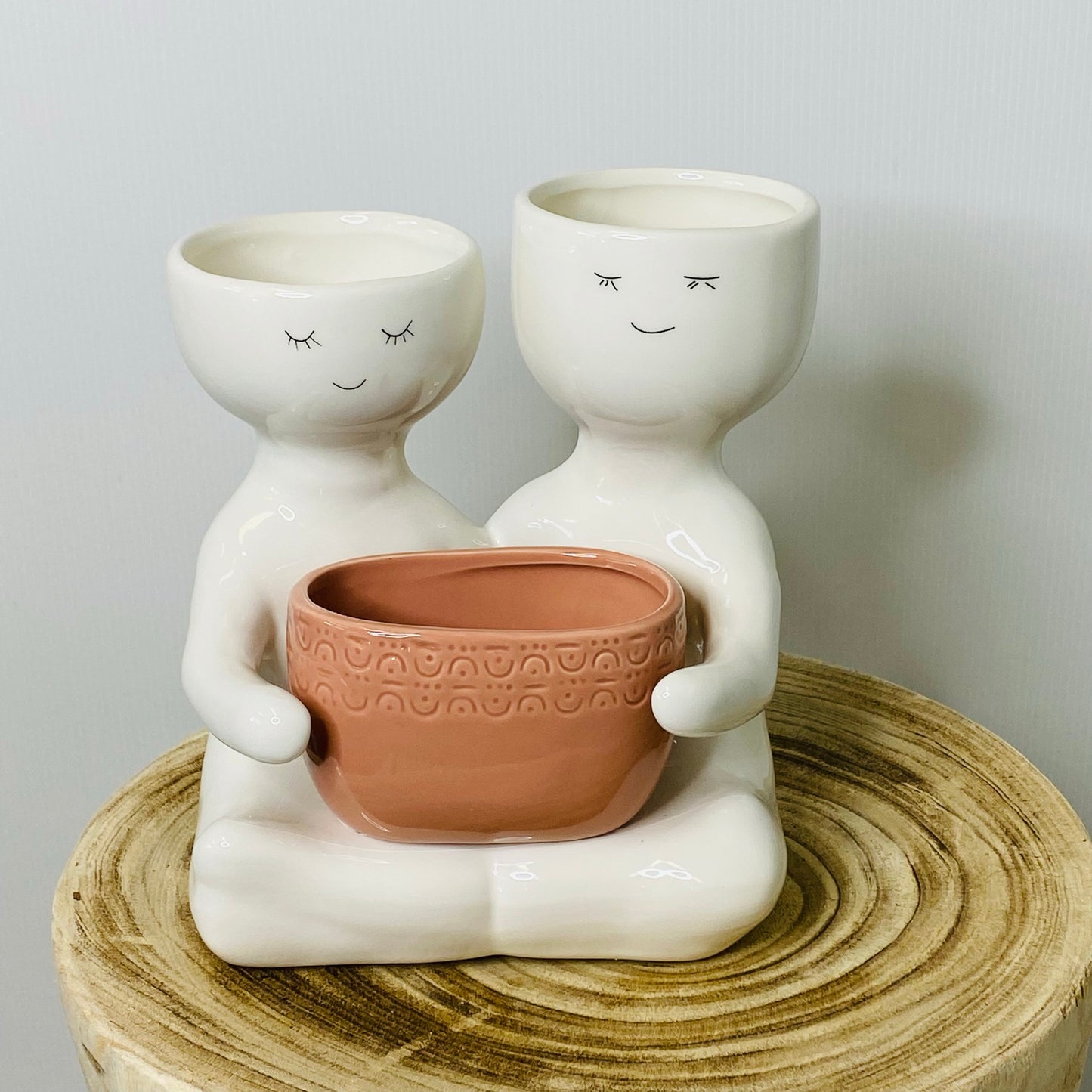 Friends holding a pot planter Rose