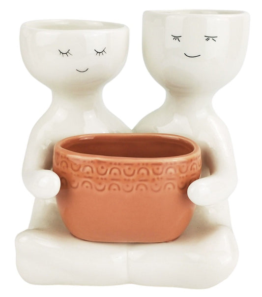 Friends holding a pot planter Rose