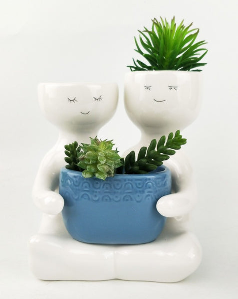 Friends holding a pot planter Blue